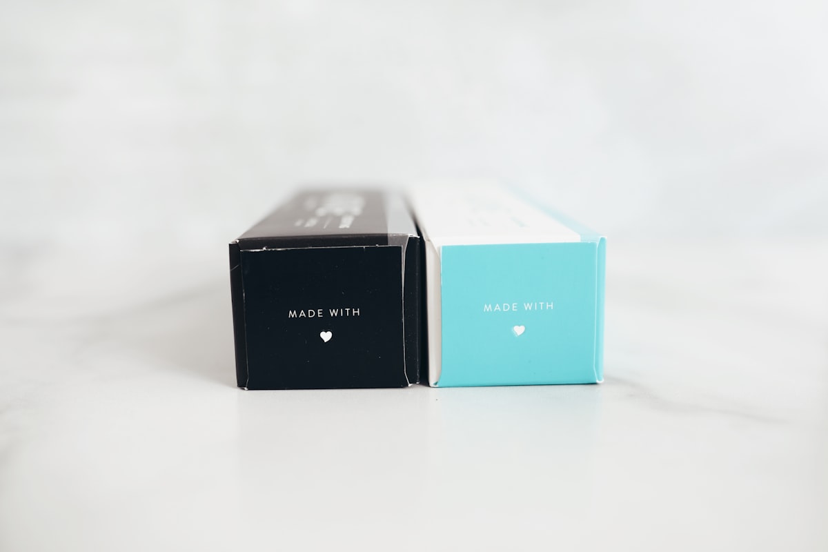 Black and red premium packaging boxes on a white table showing different box styles