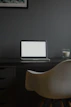 A sleek, modern workspace with a laptop displaying a clean, elegant blog layout.