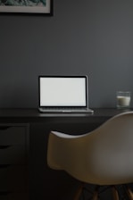 A sleek modern workspace with a laptop and shopping packages on a clean desk.
