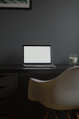 A modern workspace featuring sleek black and white decor with glass accents.