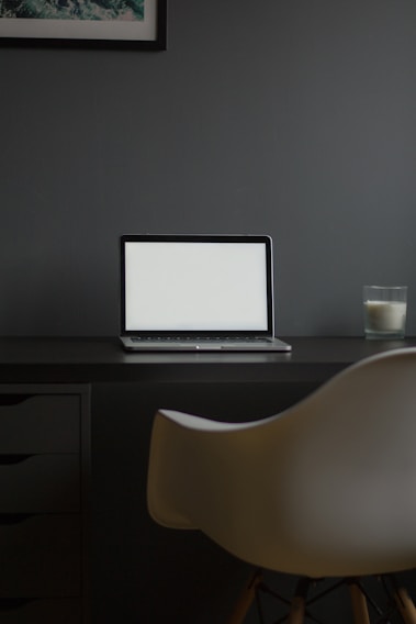 A modern office space with a sleek desk and laptop.