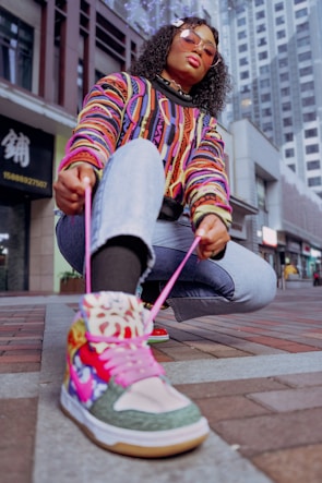 Vibrant street scene with a person wearing bold Kyo sneakers.