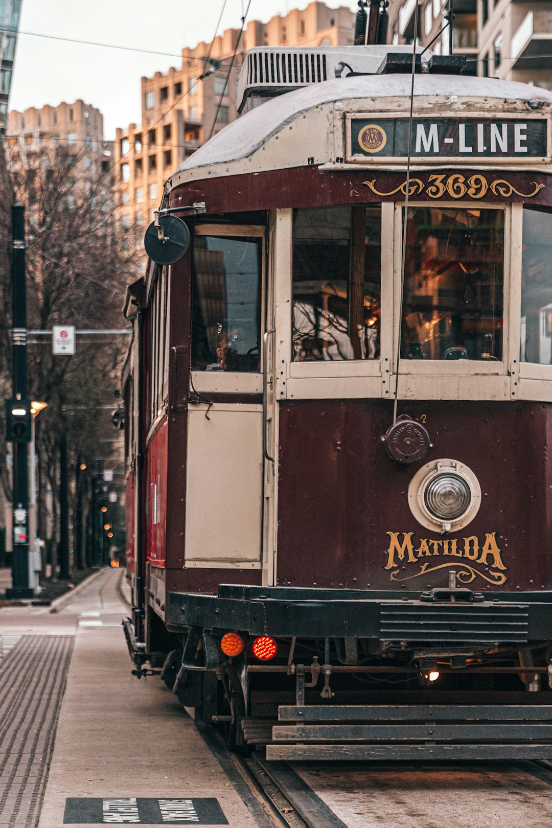 red and white tram on the street during daytime