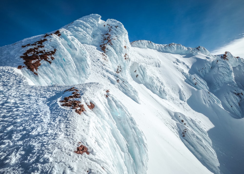 snow covered mountain under blue sky during daytime