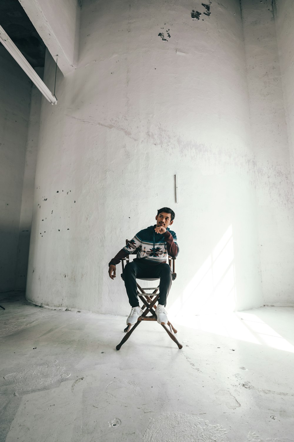 man in black and white shirt sitting on black chair