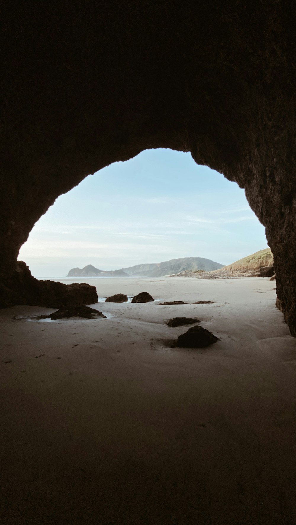 brown rock formation on beach during daytime