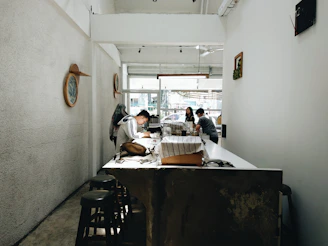 A cozy Scandinavian-style cafe interior with riperoot team members planning content around a table.