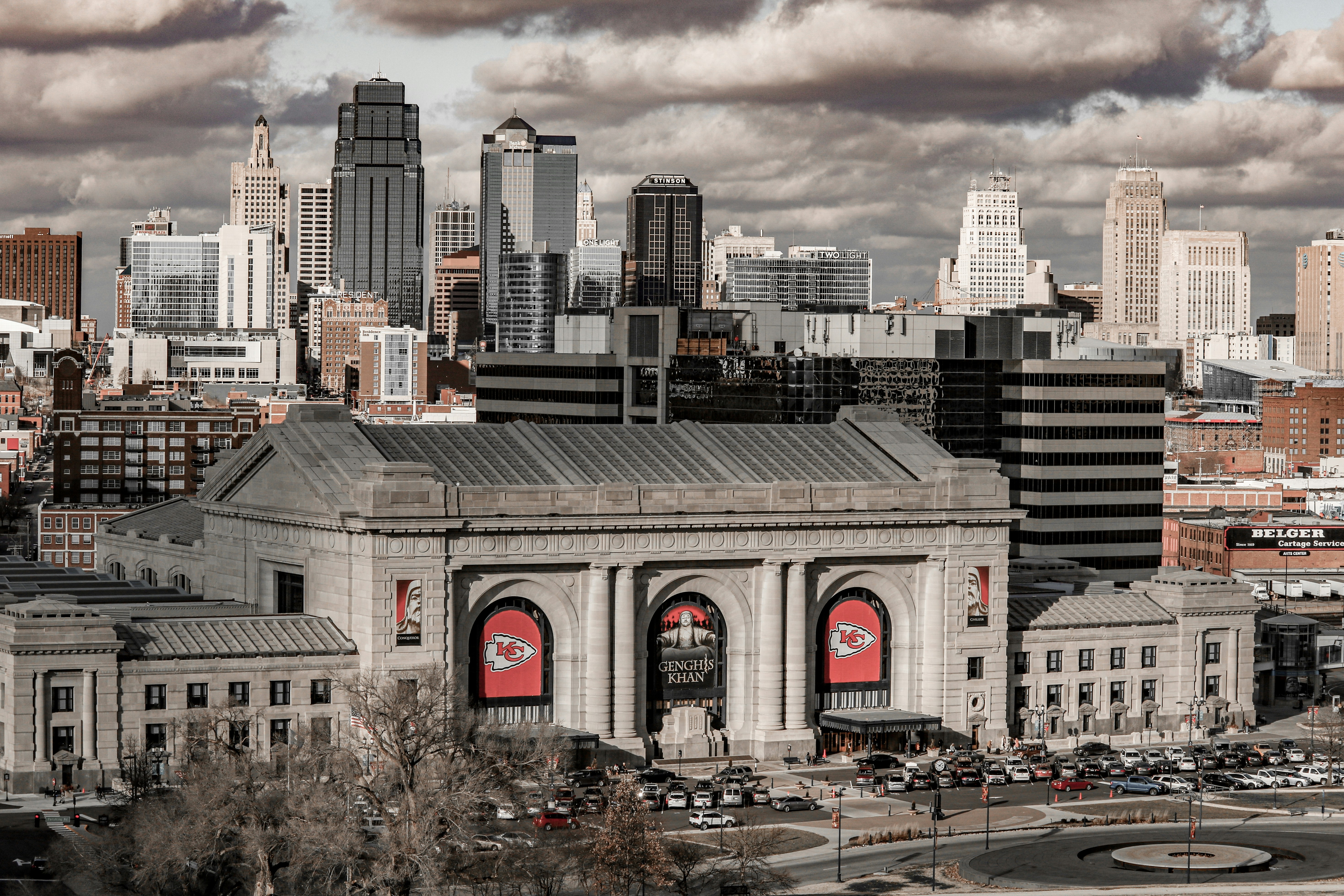 cars on road near city buildings during daytime