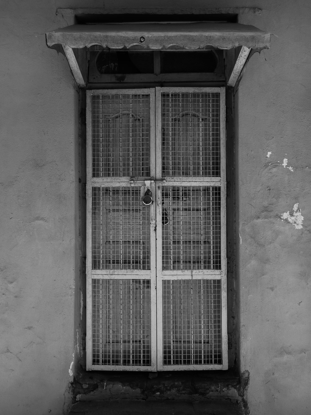 grayscale photo of closed window