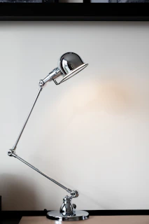 silver desk lamp on white table