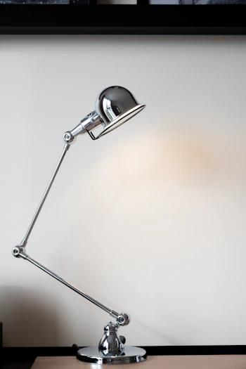 silver desk lamp on white table