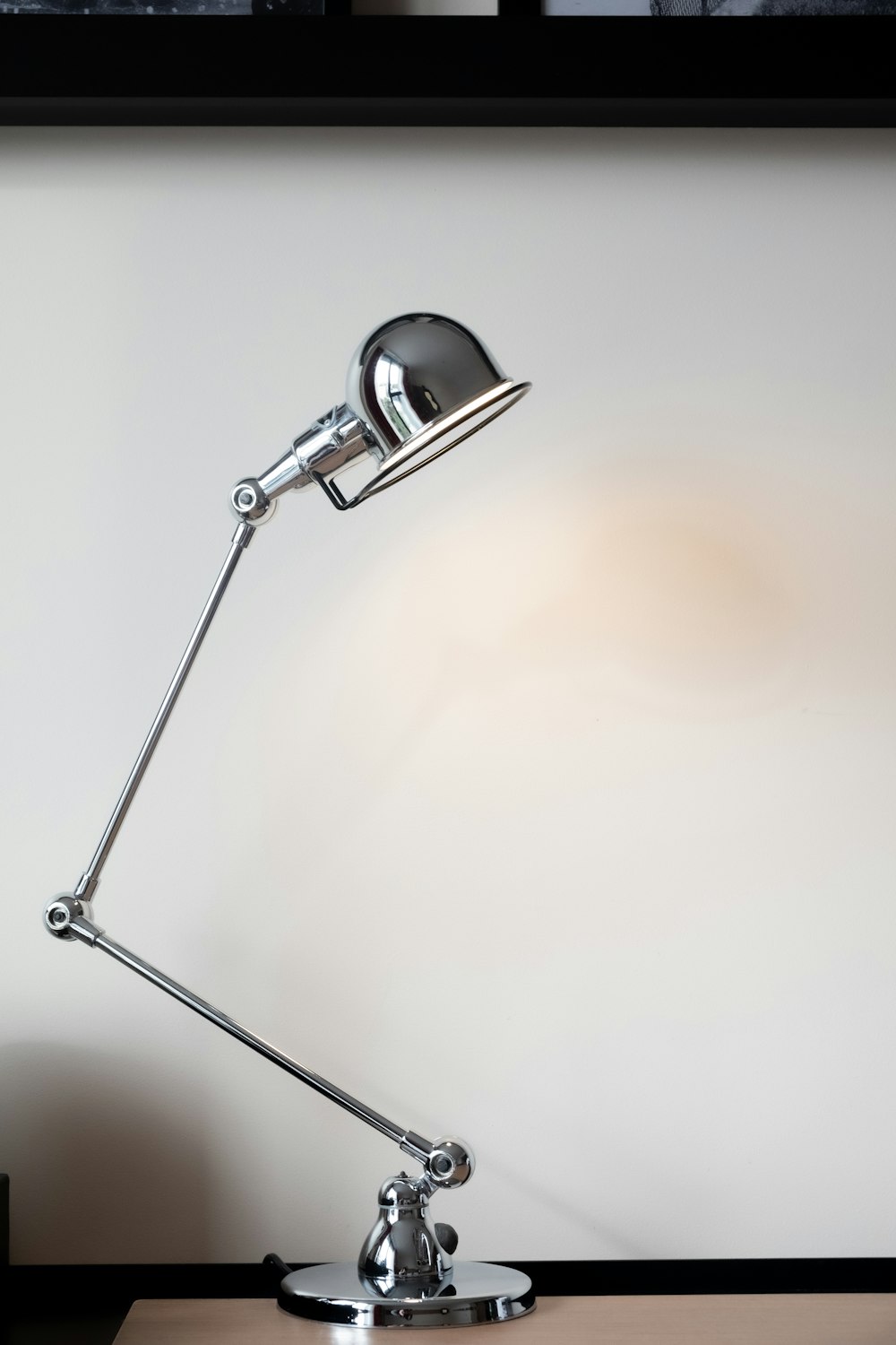 silver desk lamp on white table