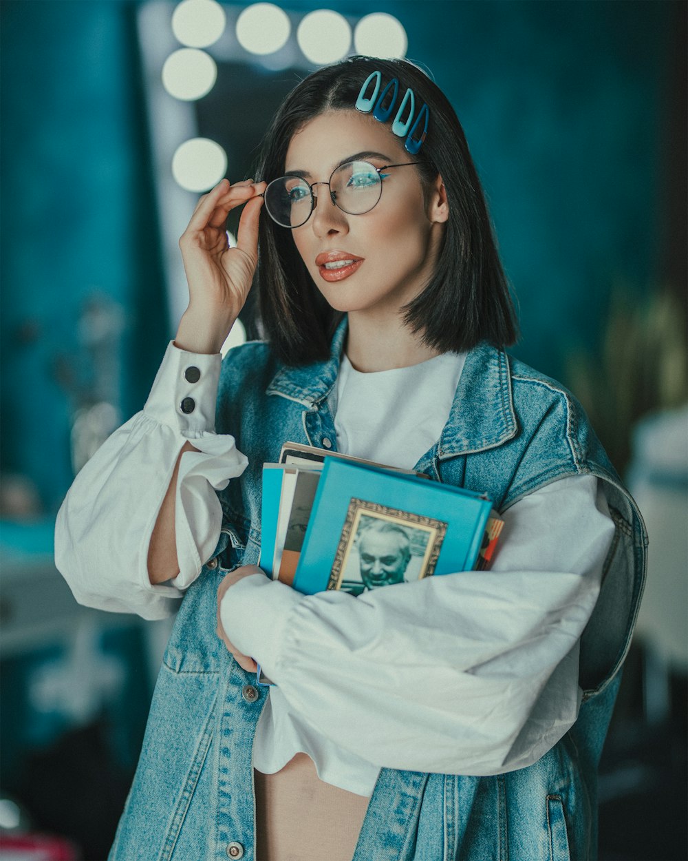 woman in white long sleeve shirt holding green book