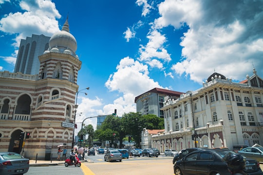 cars parked on street near brown concrete building during daytime in Merdeka Square Malaysia