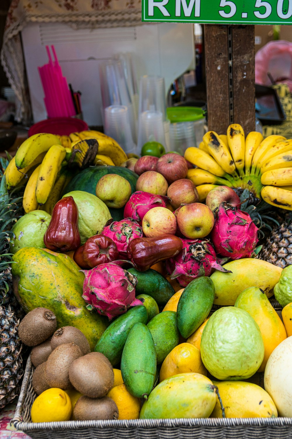 green and red fruits on brown woven basket