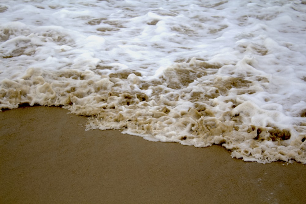 a beach with waves coming in and out of the water