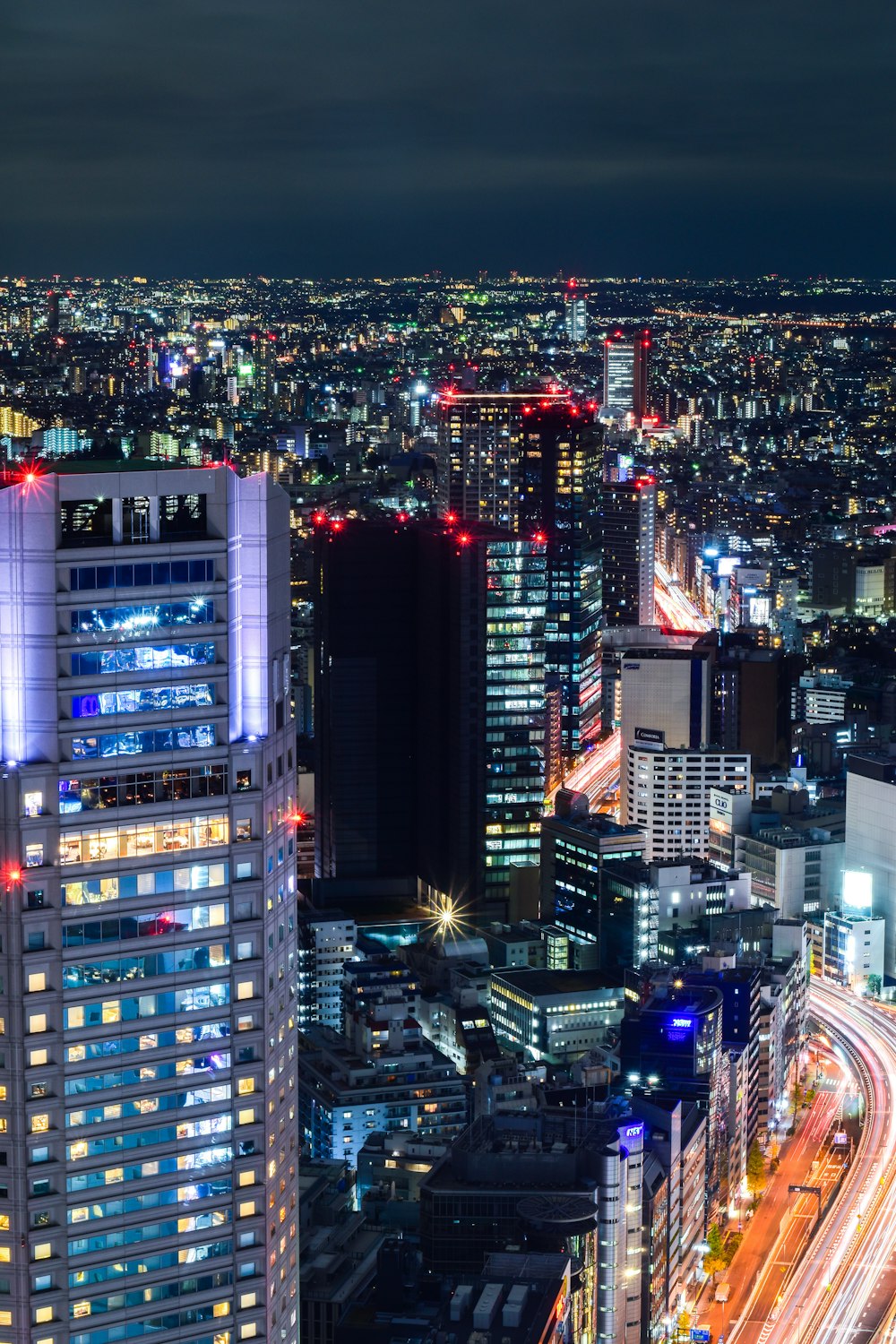 city with high rise buildings during night time