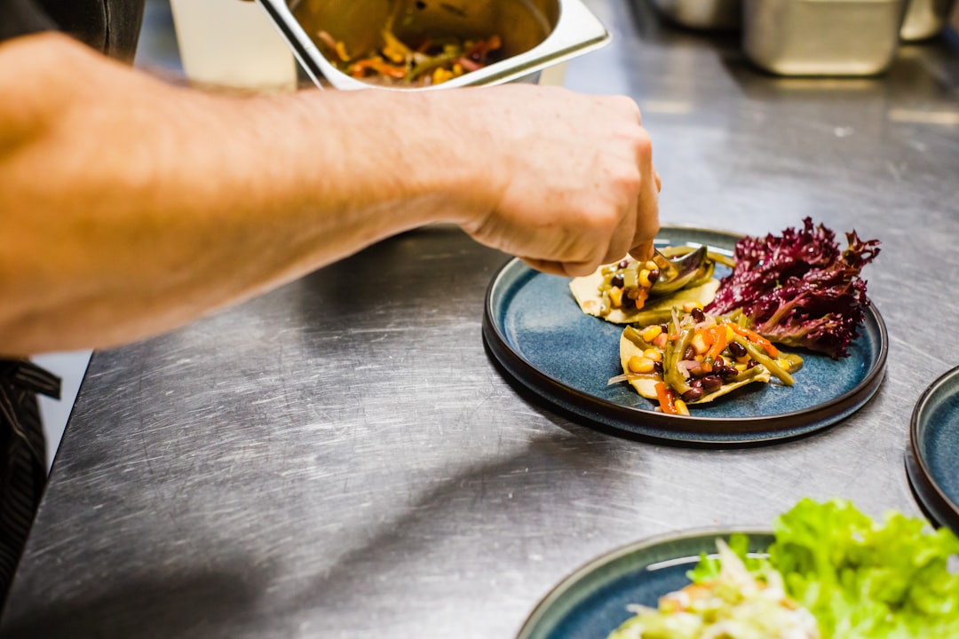 person holding stainless steel fork and knife