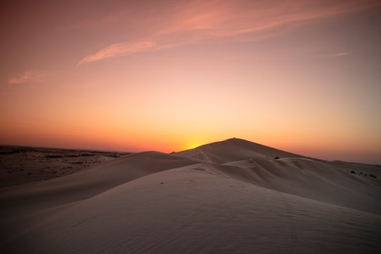 white sand under orange sky during sunset in El Oued Algeria