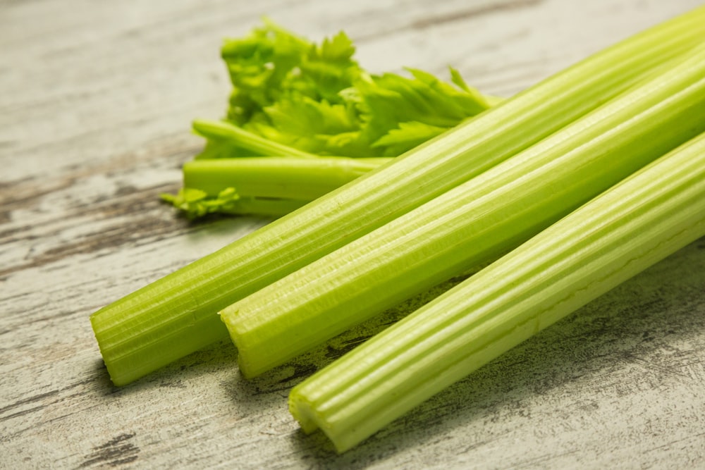 green vegetable on gray wooden table