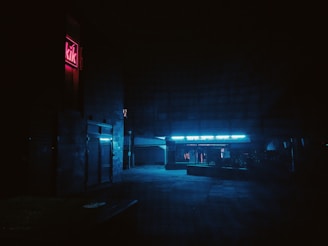 A moody 1950s noir city street scene with deep shadows and glowing neon signs
