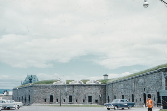 cars parked near gray concrete building during daytime in Québec Canada