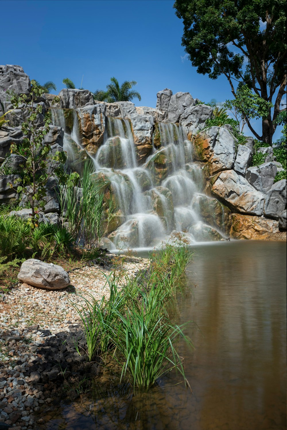 water falls on rocky shore during daytime