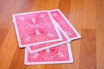 Close-up of colorful playing cards fanned out on a wooden surface.