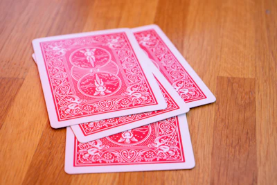 Close-up of colorful playing cards fanned out on a wooden surface.