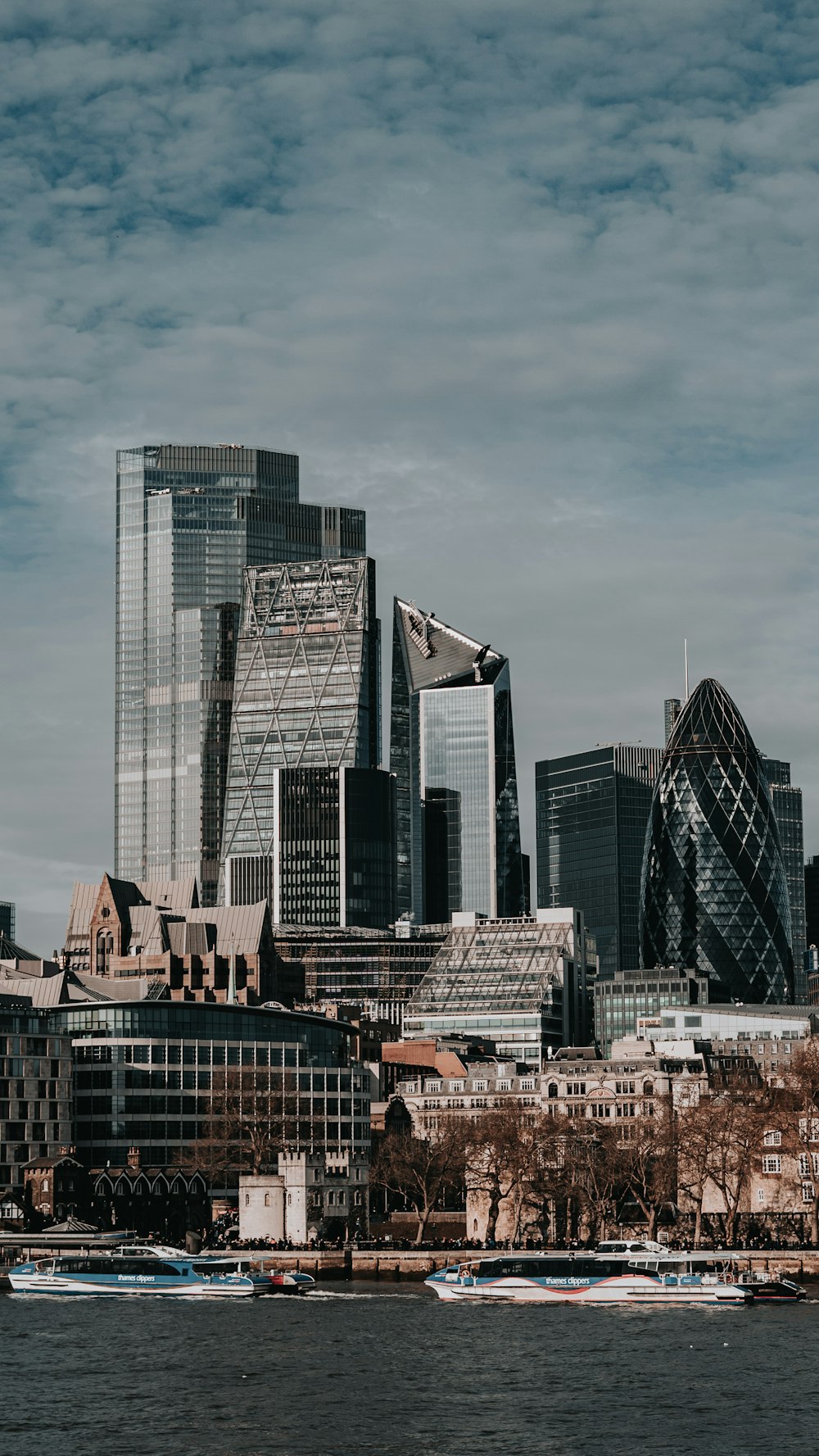 high rise buildings under white clouds during daytime