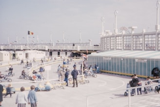 A group of kids racing down a hill with colorful soapbox carts.