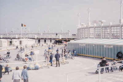 Families and kids enjoying the kart park with colorful karts lined up.