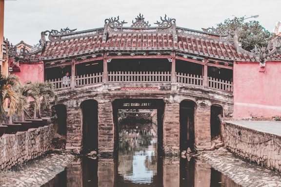 brown concrete building near body of water during daytime