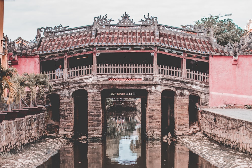 brown concrete building near body of water during daytime