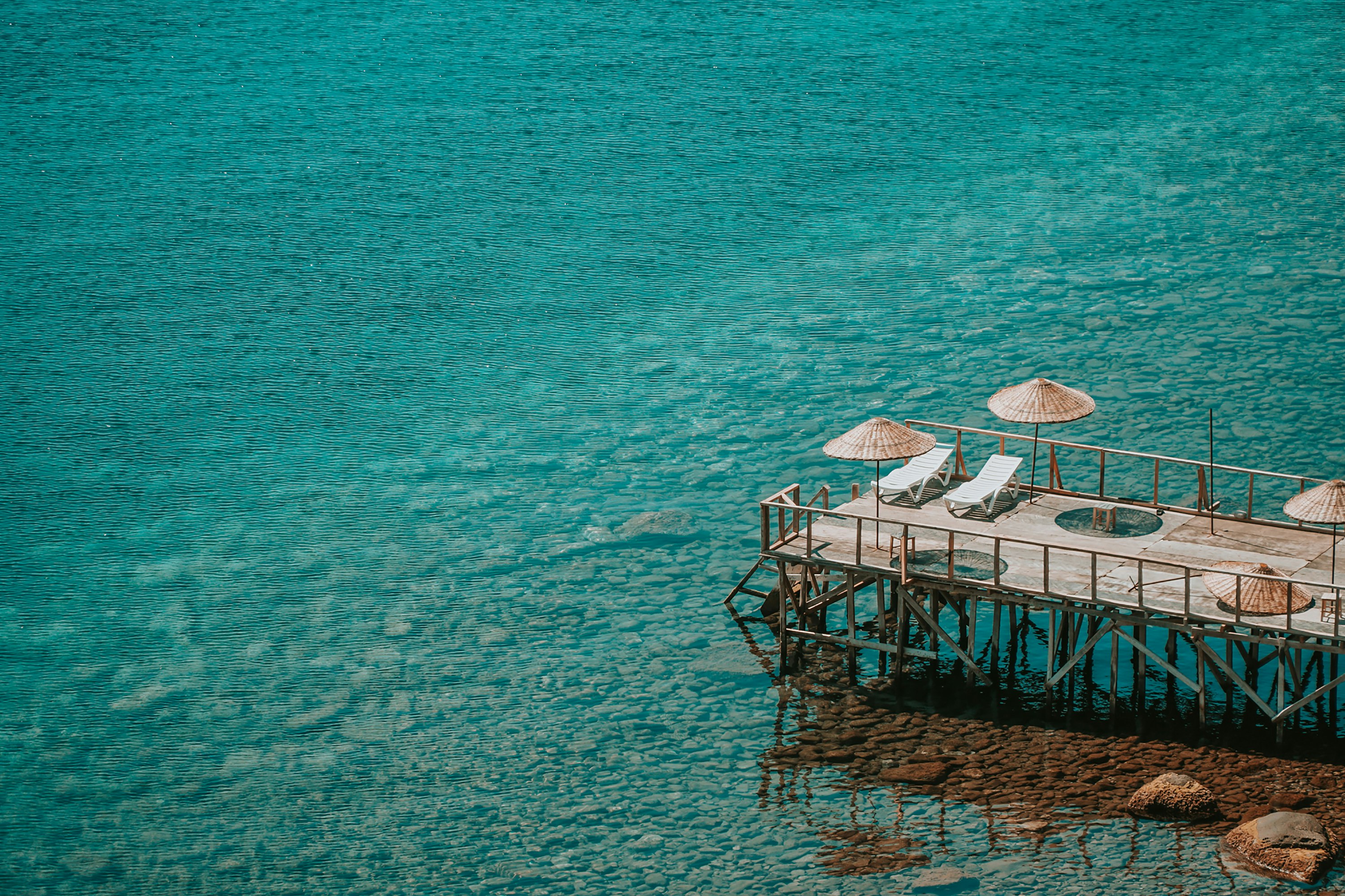 brown wooden dock on body of water during daytime