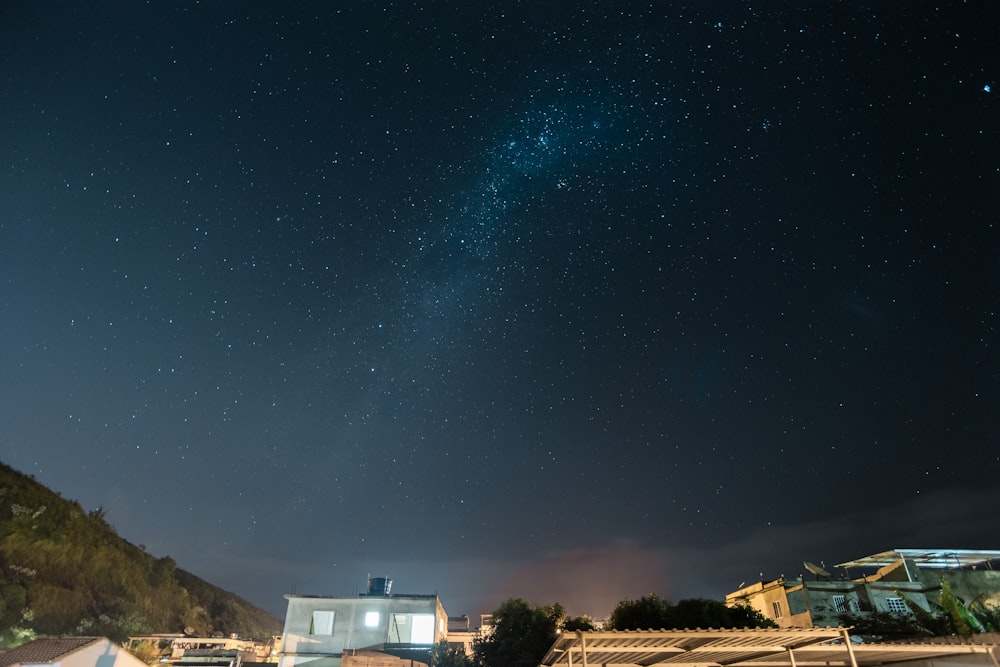 white and brown house under blue sky during night time