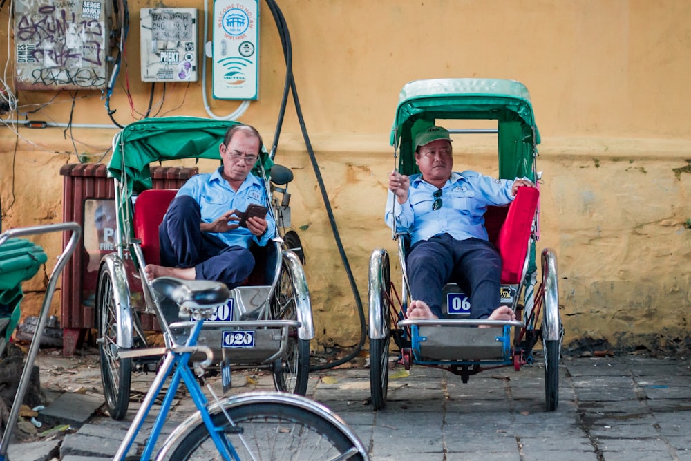 man in blue jacket sitting on red and black wheelchair