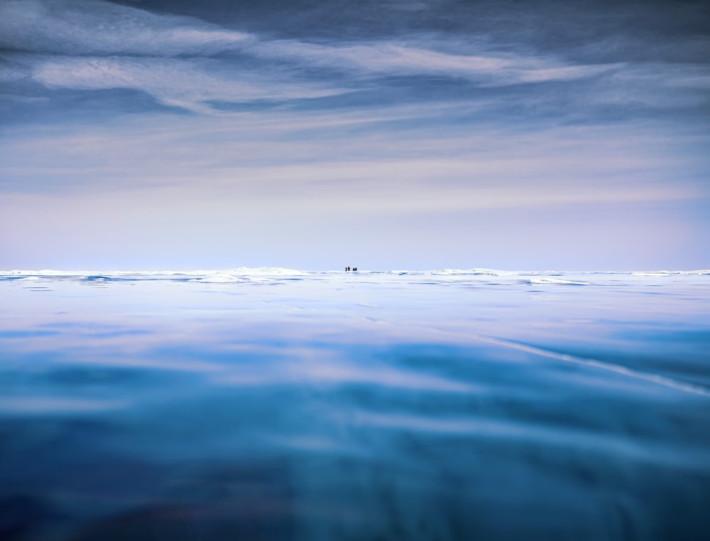 body of water under cloudy sky during daytime