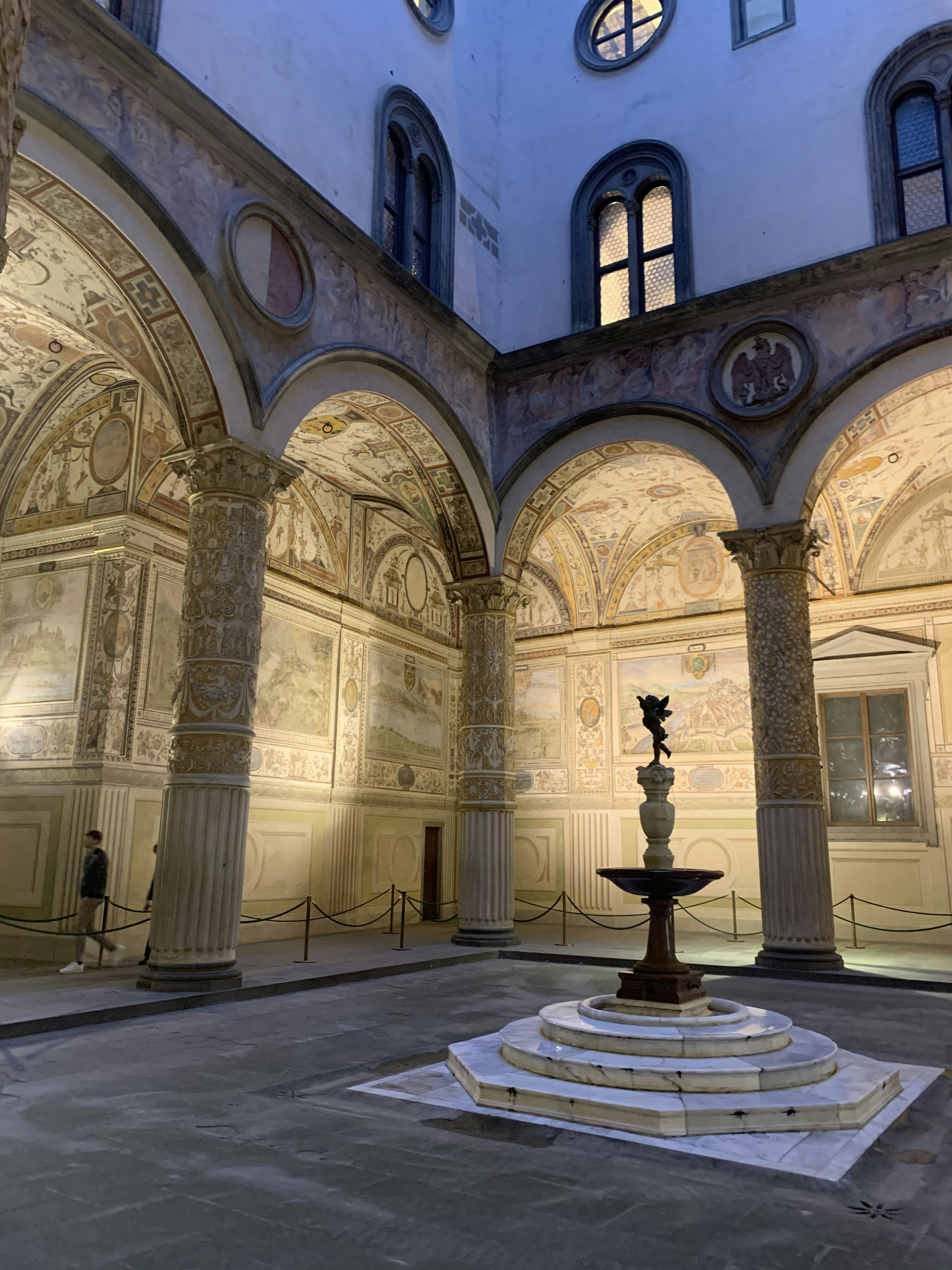 white concrete building with black statue