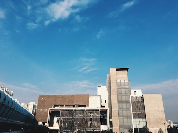 Wide view of a freshly painted modern building under a clear blue sky.