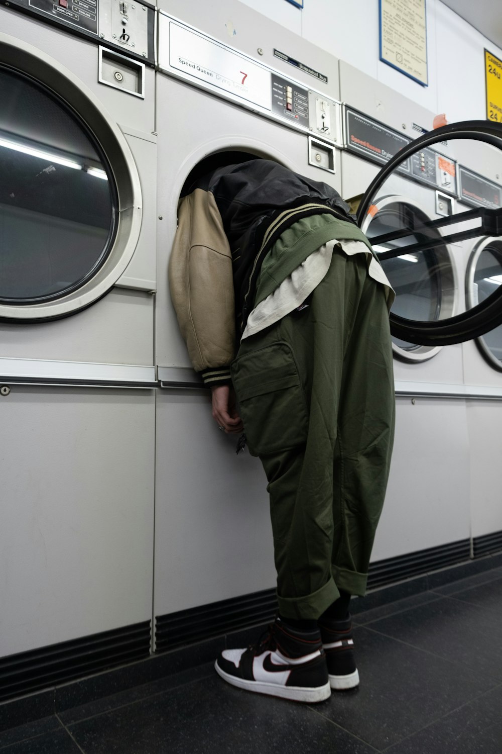 green jacket on white front load washing machine