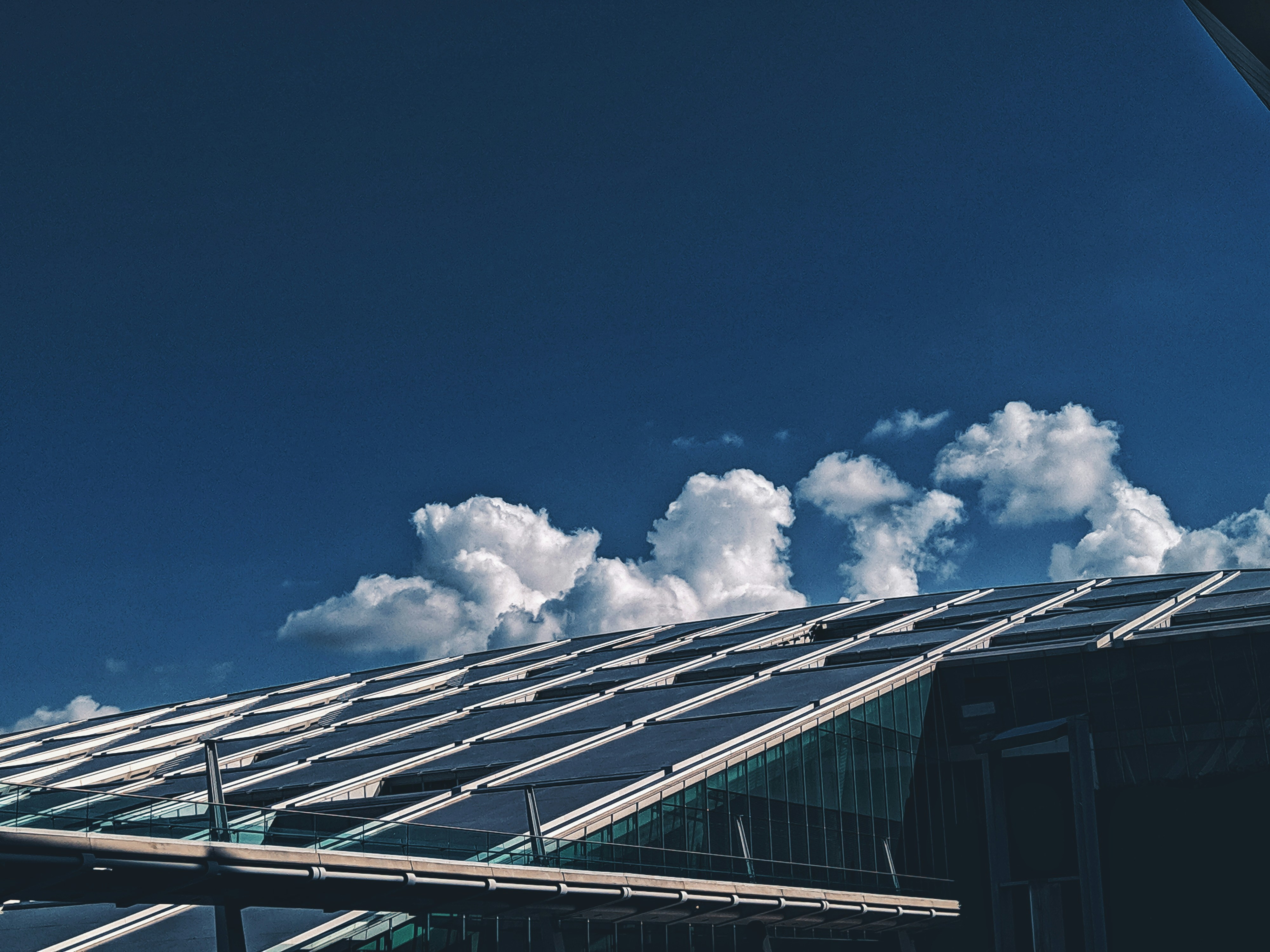 Modern Australian home with solar panels installed on roof under blue sky