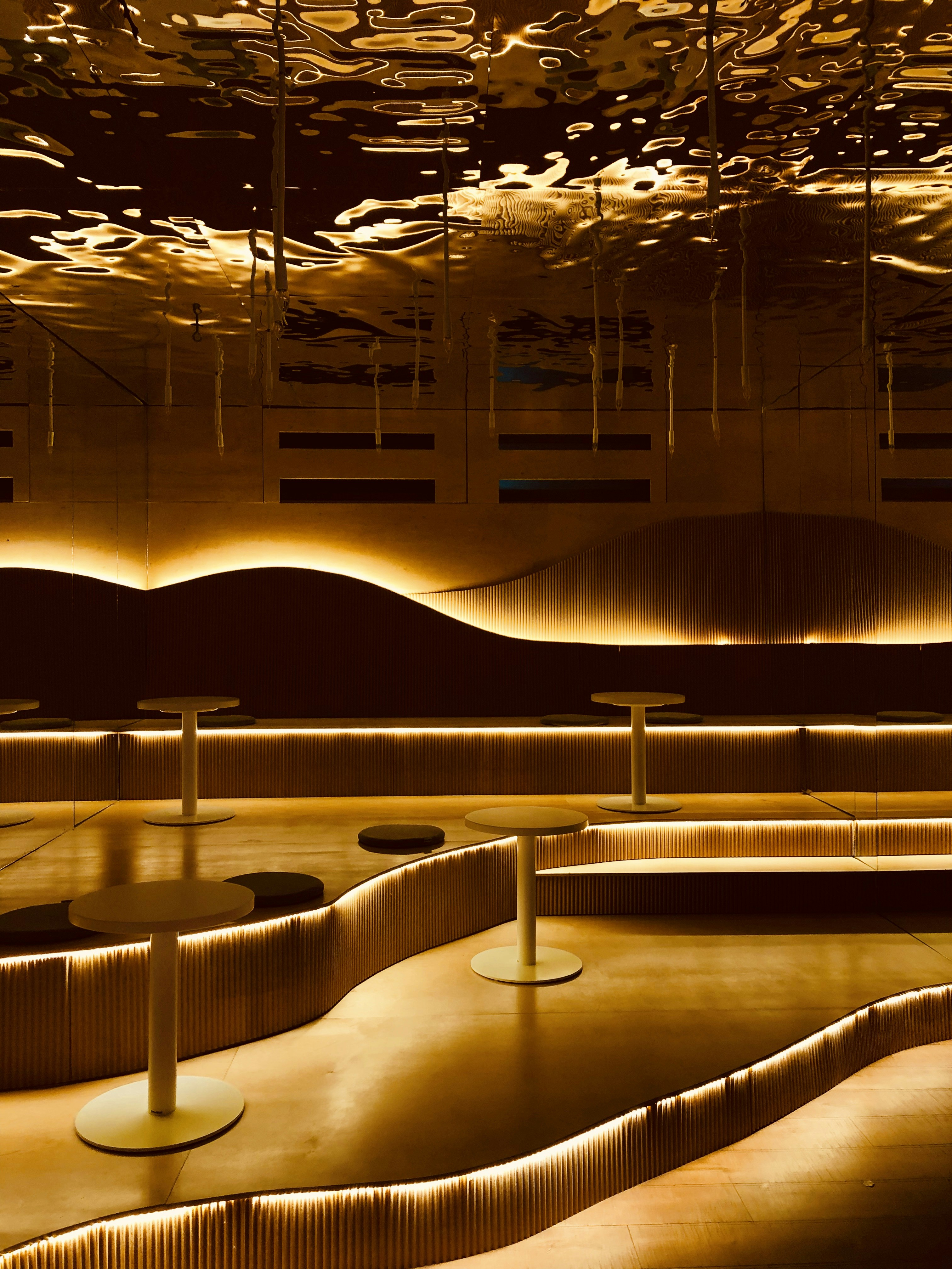 Modern interior with rounded architecture and golden lighting.