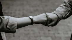 person wearing silver link bracelet watch