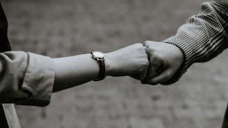 A close-up of hands high-fiving after a successful workout session.