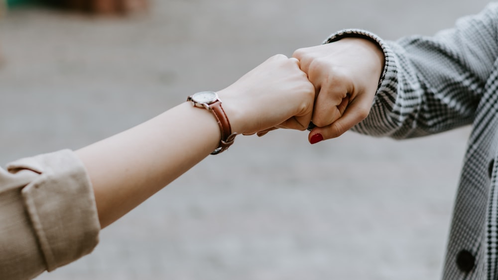 person wearing silver bracelet and bracelet