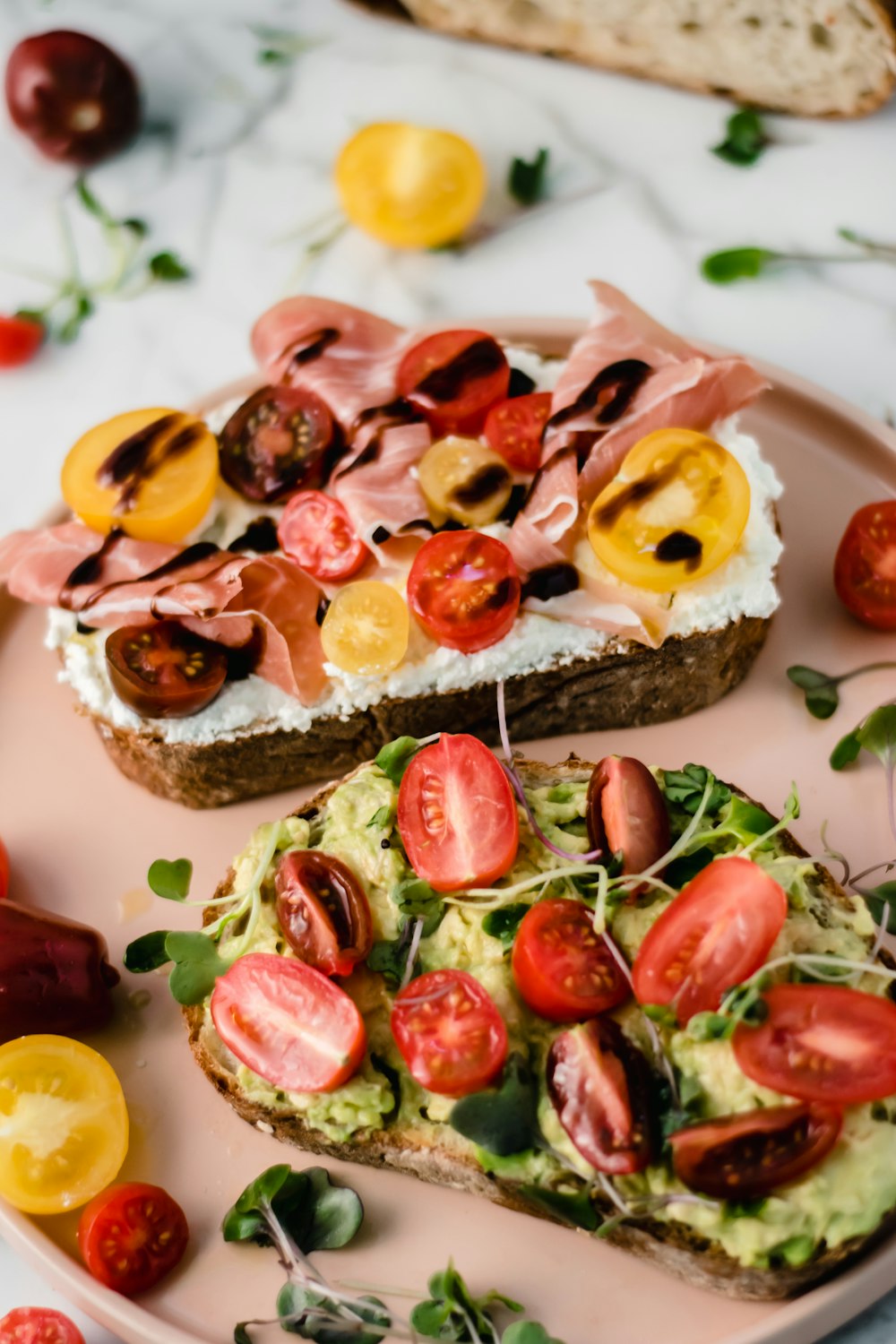 bread with sliced tomato and green vegetable on white ceramic plate