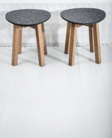 Rustic barstool made of reclaimed wood with a sturdy square seat and simple design.