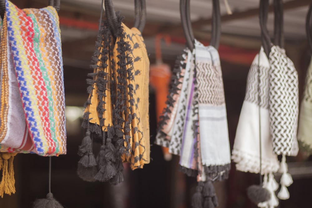 assorted color clothes hanged on black metal rack