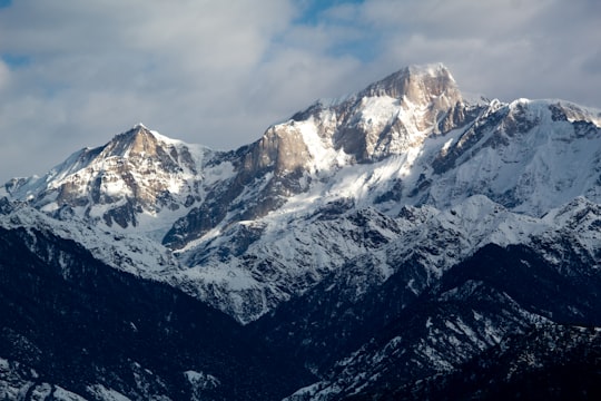 snow covered mountain under blue sky during daytime in Uttarakhand India